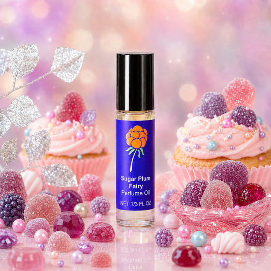 Cloudberry Beauty Sugar Plum Fairy Perfume Oil surrounded by pink cupcakes, gumdrops and sparkling candy.