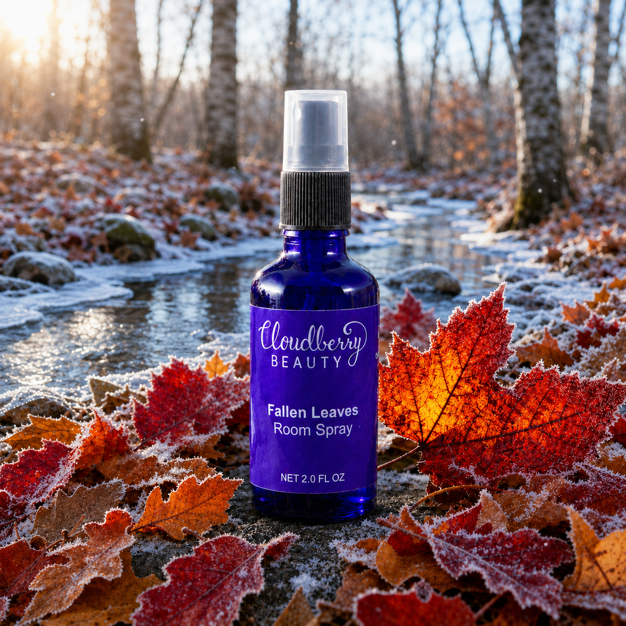 Cloudberry Beauty Fallen Leaves Room Spray among frosted red autumn leaves beside a woodland stream.