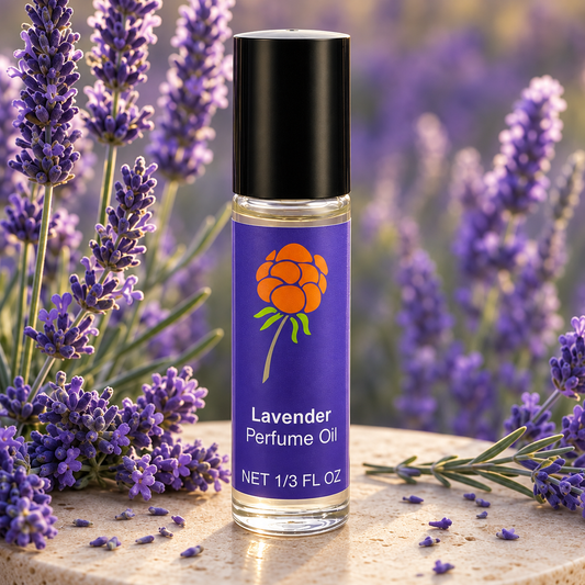 Close-up of Cloudberry Beauty Lavender Perfume Oil roll-on bottle displayed among blooming lavender.