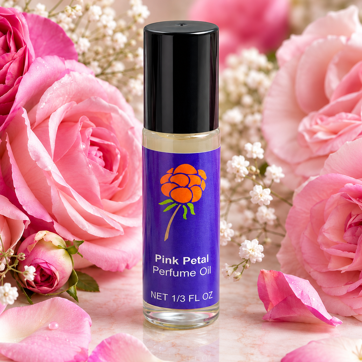 Close-up of Cloudberry Beauty Pink Petal Perfume Oil roll-on bottle surrounded by lush pink roses and petals.